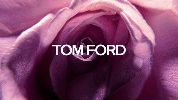 Close-up of a purple rose with the Tom Ford brand name overlaid in white text, showcasing floral aesthetics and a beauty or fashion theme.