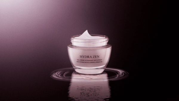 A jar of Hydra Zen gel-creme anti-stress moisturizing cream sits in a studio setting with light reflecting off the surface.