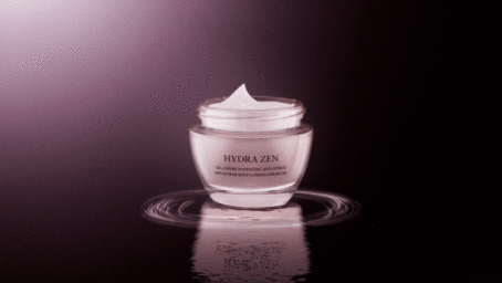 Jar of Hydra Zen moisturising cream on a dark reflective surface with a soft purple vignette gradient.