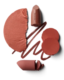 Deconstructed mauve lipstick pieces and swatches arranged symmetrically on a clean white background