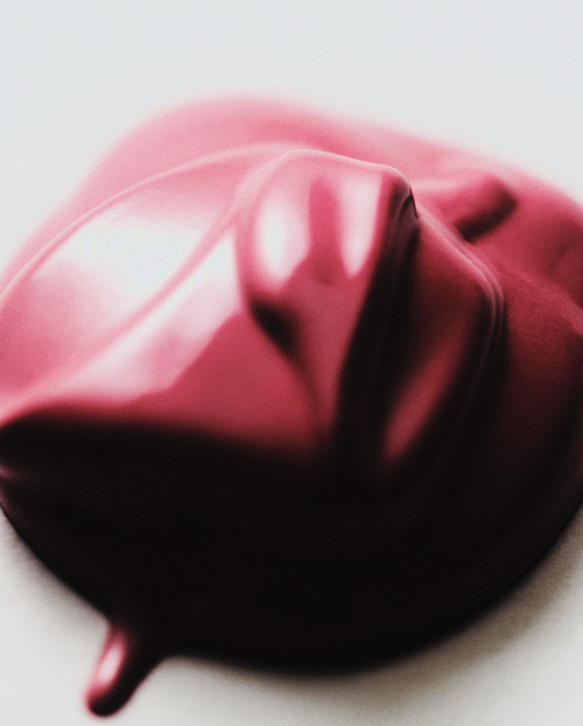 Close-up shot of vibrant pink cosmetic cream with a glossy texture on a white background, ideal for beauty and product visualization.