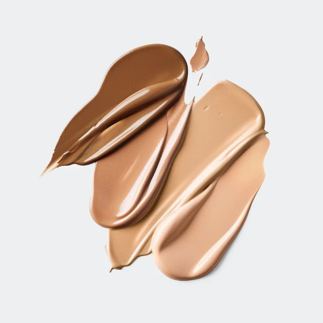 Close-up of foundation swatches in various shades of brown and beige on a white background, beauty and cosmetics concept for makeup.