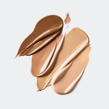 Close-up of foundation swatches in various shades of brown and beige on a white background, beauty and cosmetics concept for makeup.