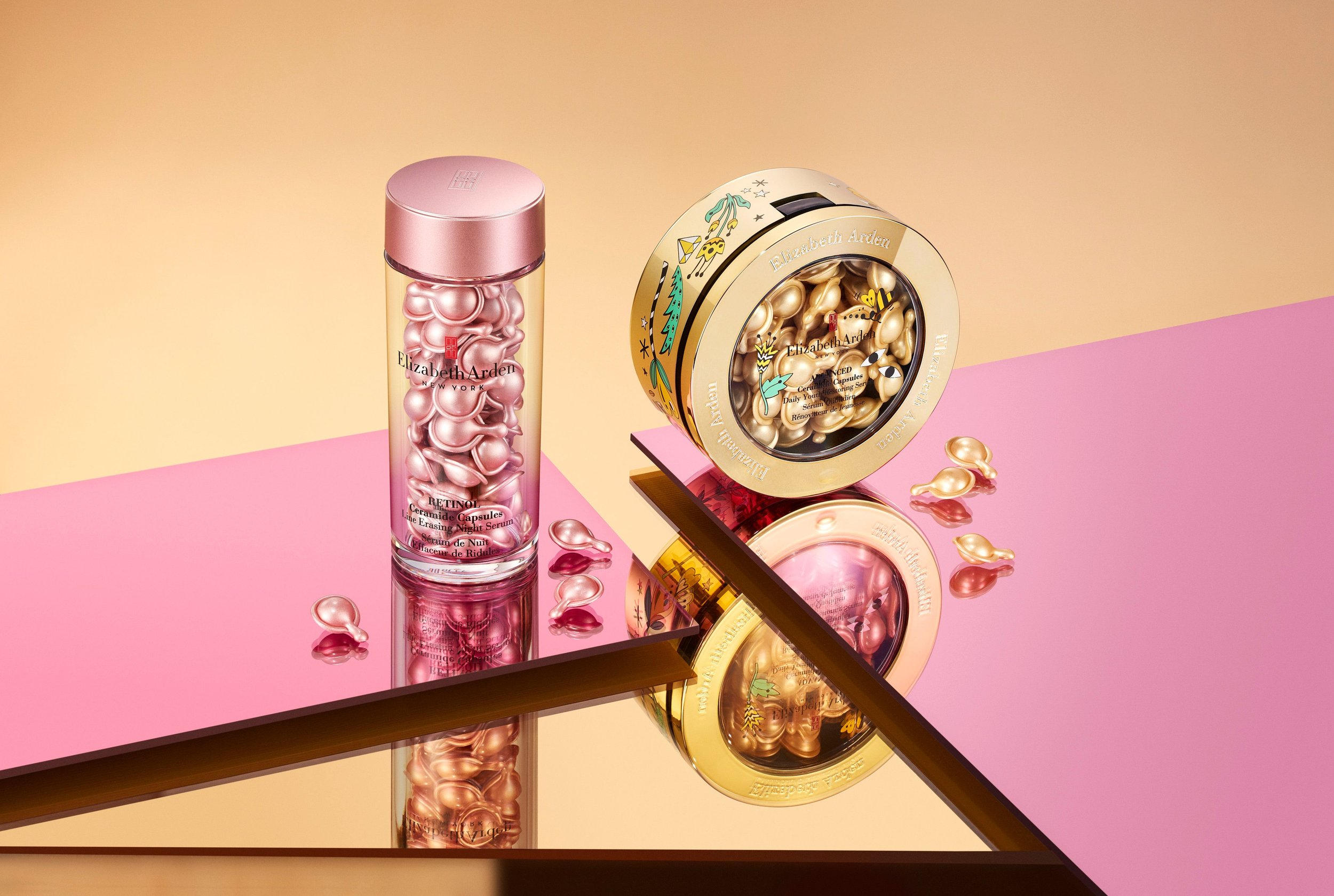 Two Elizabeth Arden Retinol Ceramide Capsules products are showcased on a pink and gold reflective surface, featuring a container and box.
