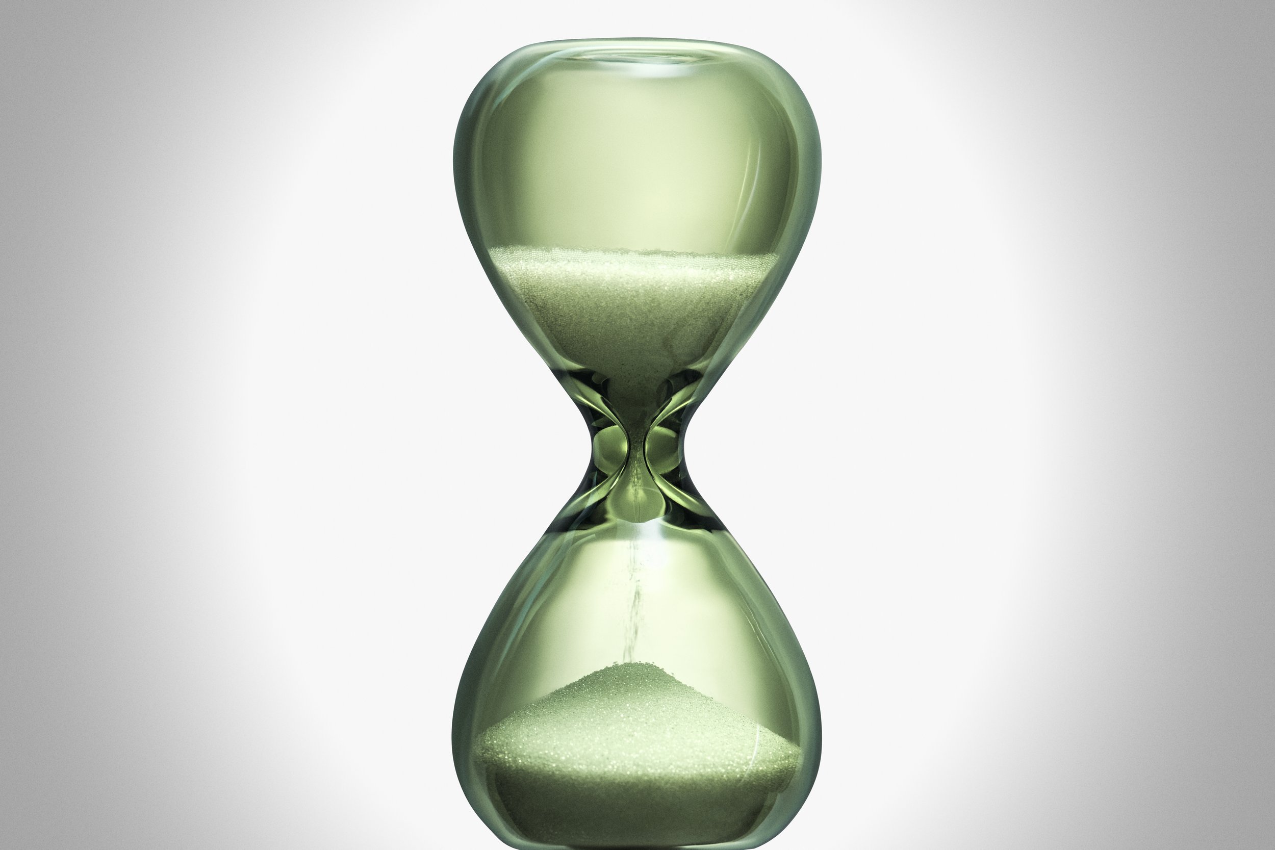 Hourglass on a gradient background with sand collecting at the bottom, symbolizing the passage of time in a pale green hue.