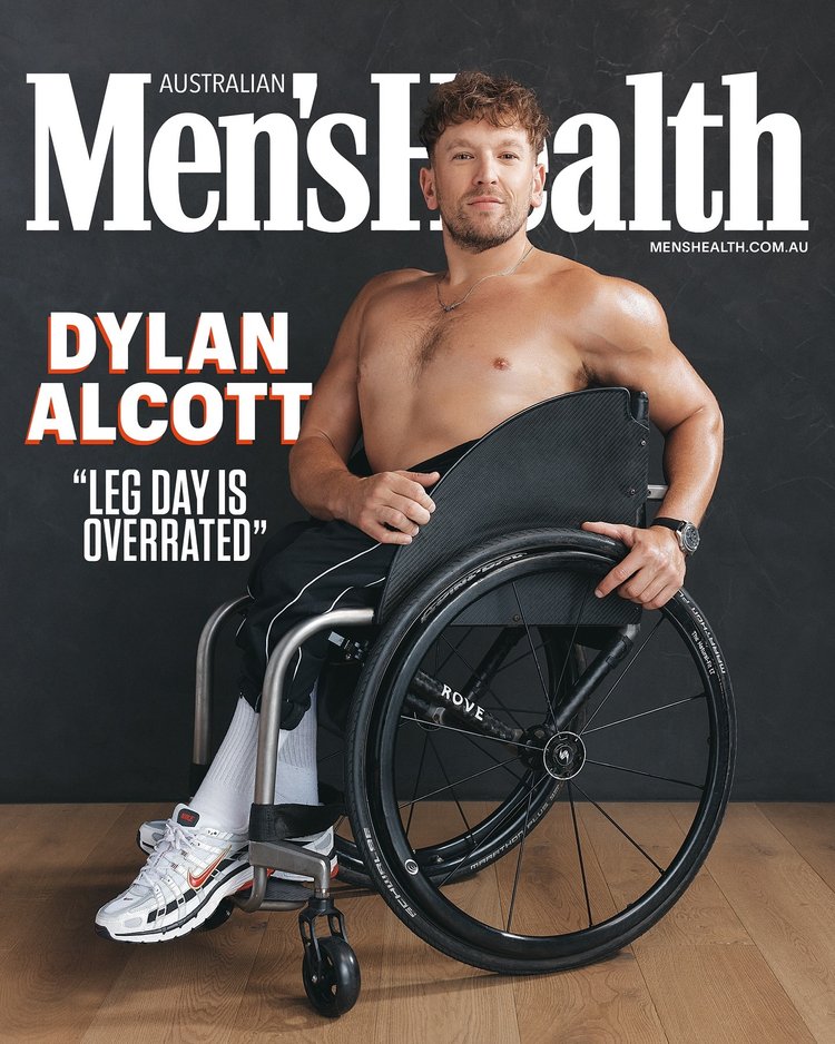 Dylan Alcott, athlete in wheelchair, poses shirtless on cover of Australian Men's Health with gray studio backdrop and wood floor.