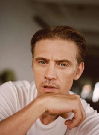 Close-up portrait of a man in a white t-shirt resting his chin on his hand by photographer Ryan Brabazon
