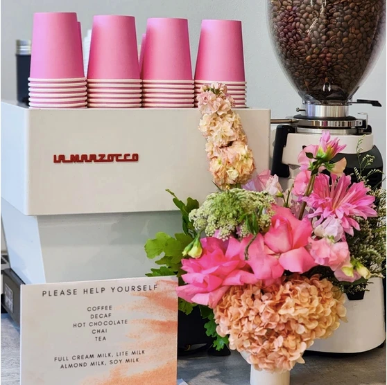 Espresso machine with pink coffee cups and floral arrangement by Pullin Shots in Sydney