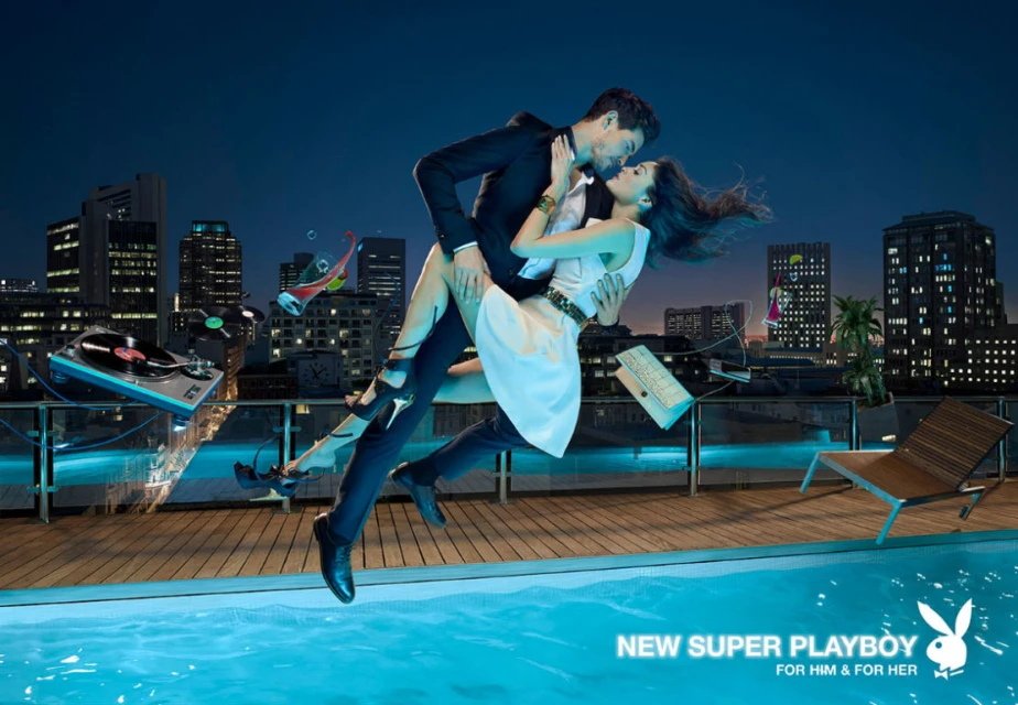 Couple in formal wear in mid-air embrace on rooftop terrace. Floating objects, city skyline, pool, nighttime, visual effects.