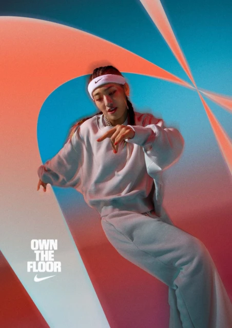 Athletic woman in a white tracksuit and headband poses dynamically against an abstract blue and orange background with a Nike logo.