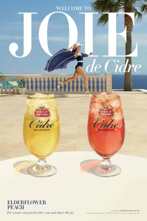 Stella Artois Cidre ad featuring a woman in a swimsuit running on a balcony overlooking the ocean with two glasses of cider.