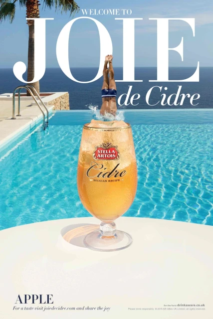 Stella Artois Cidre ad featuring a swimmer diving into a pool with a drink glass in the foreground, set against a sunny poolside scene.