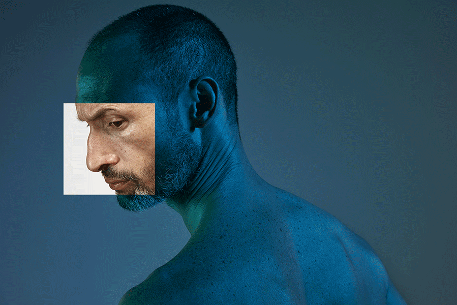 Creative portrait of an adult man featuring a close-up profile view inset in a square, with blue and green lighting against a dark background.