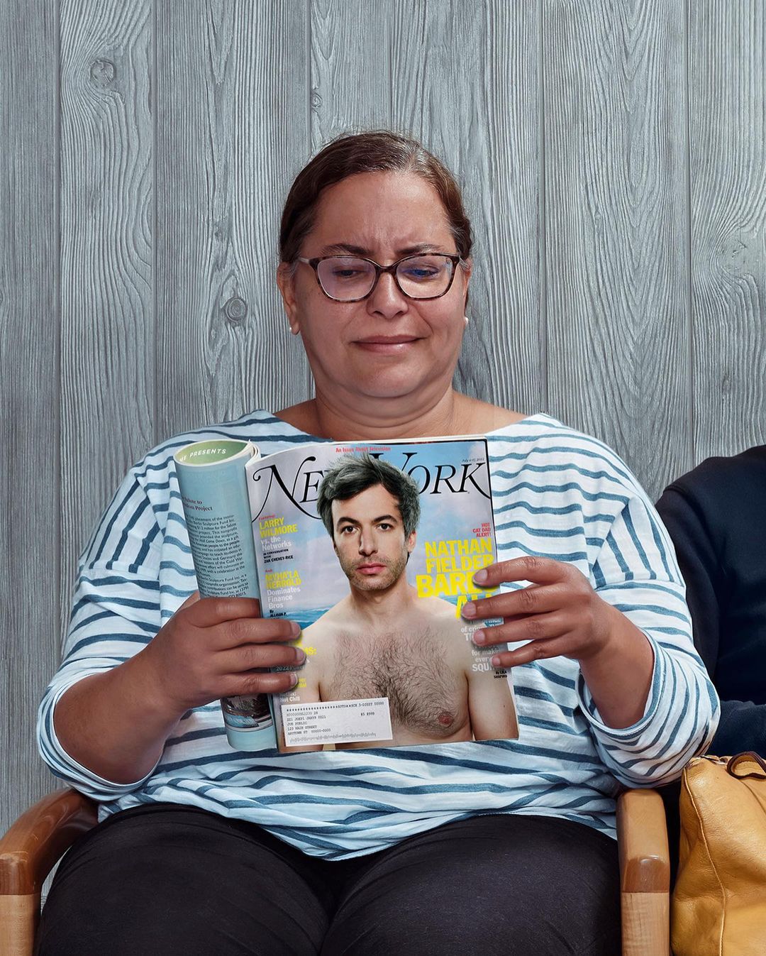 Middle-aged woman wearing glasses and striped shirt holding a magazine in a portrait by Zachary Scott
