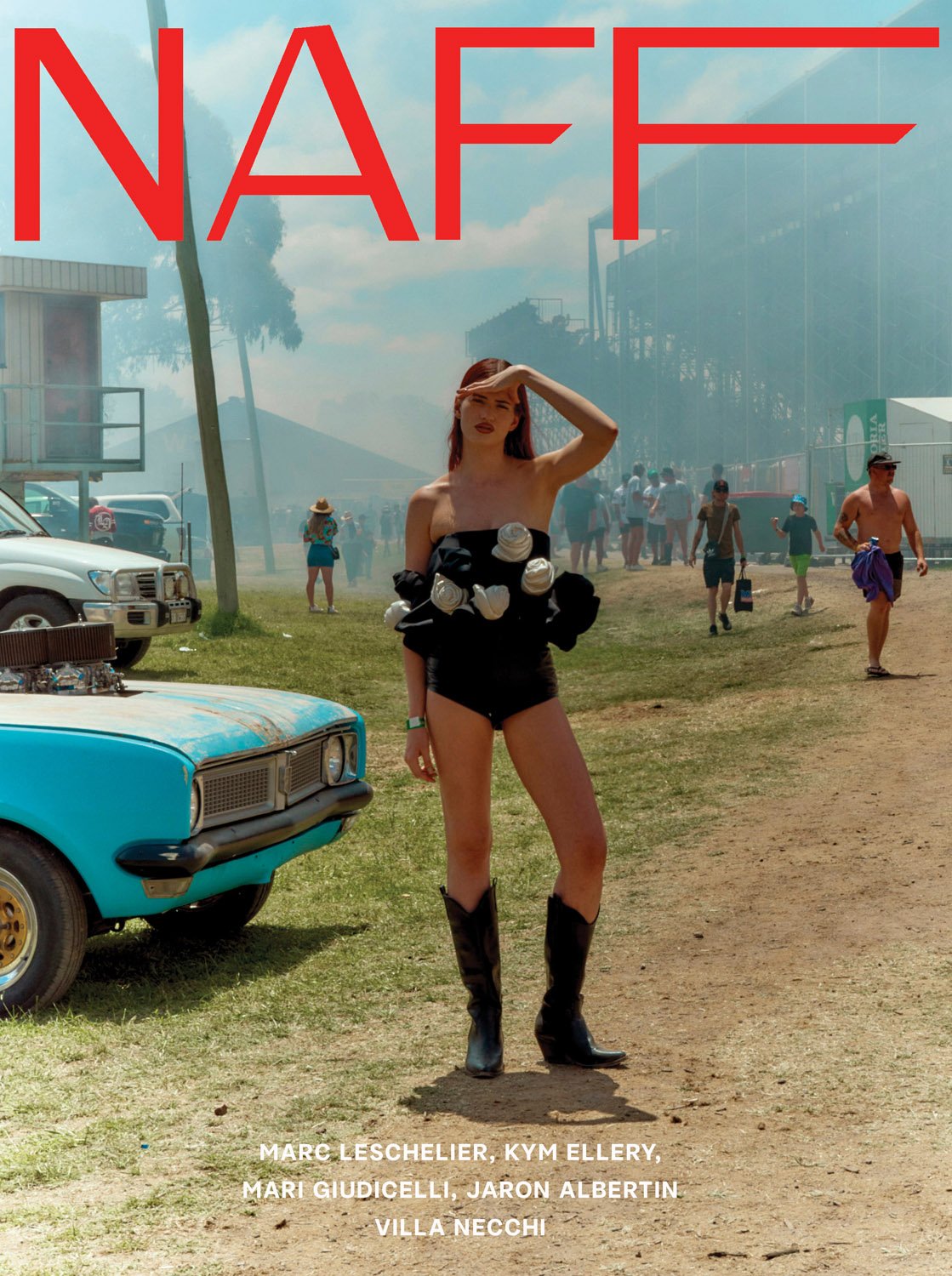 Fashion editorial shot of a woman posing in a black swimsuit and boots near a vintage car with a crowd in the background.
