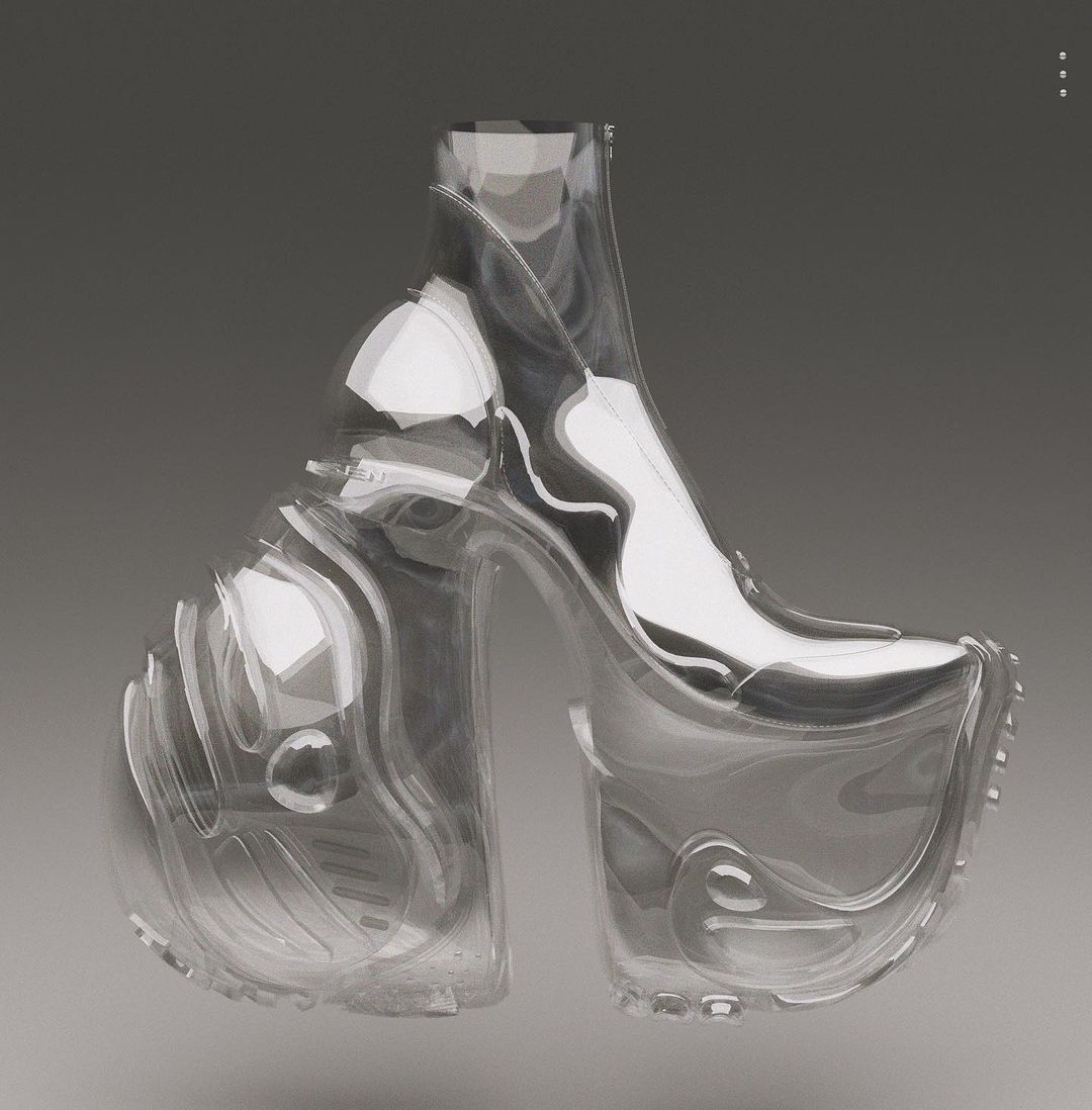 A pair of avant-garde clear platform boots with a visible inner structure are set against a neutral grey background.
