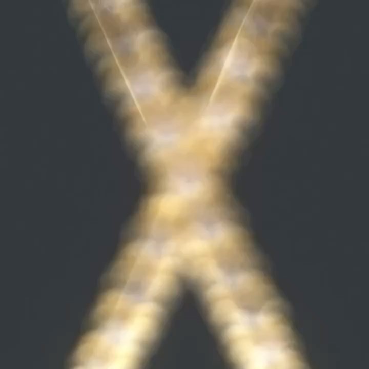 Abstract X shape formed by golden lights or smoke against a dark background creating a modern and minimalist visual.