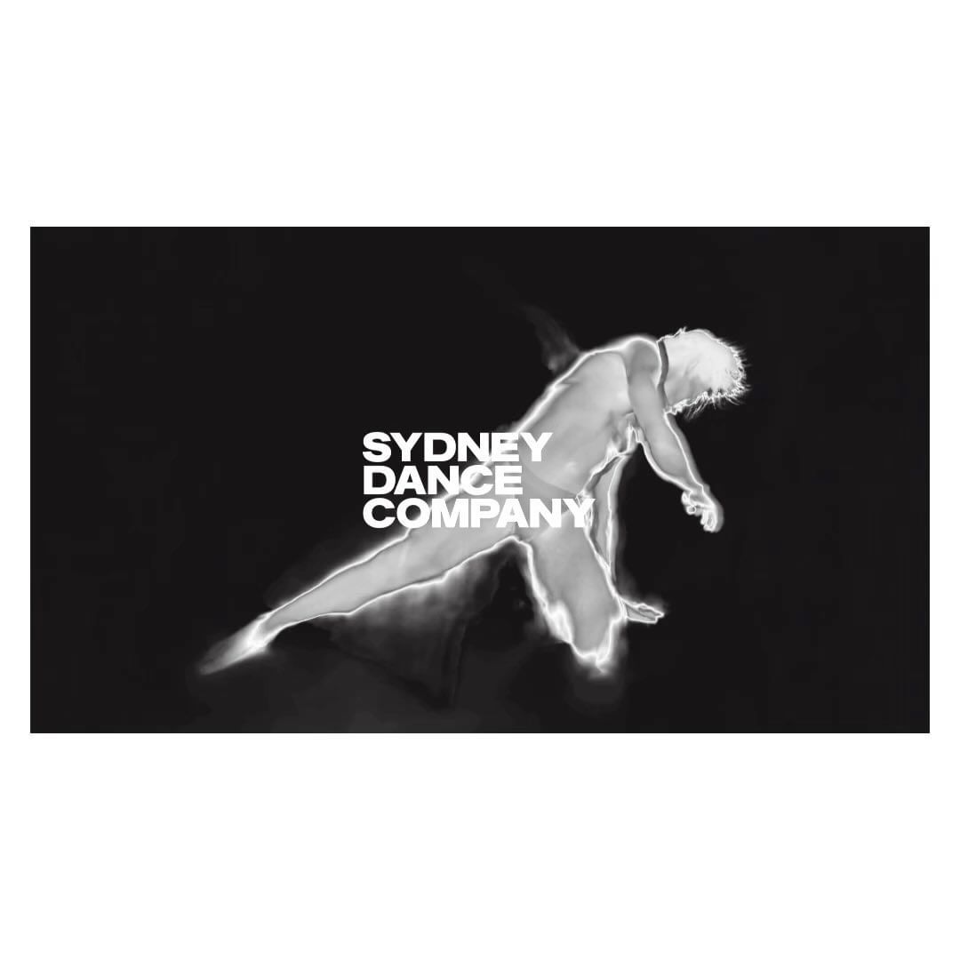 Monochromatic image of a male dancer in motion, set against a dark background with the 'Sydney Dance Company' logo.