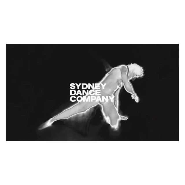 Monochromatic image of a male dancer in motion, set against a dark background with the 'Sydney Dance Company' logo.