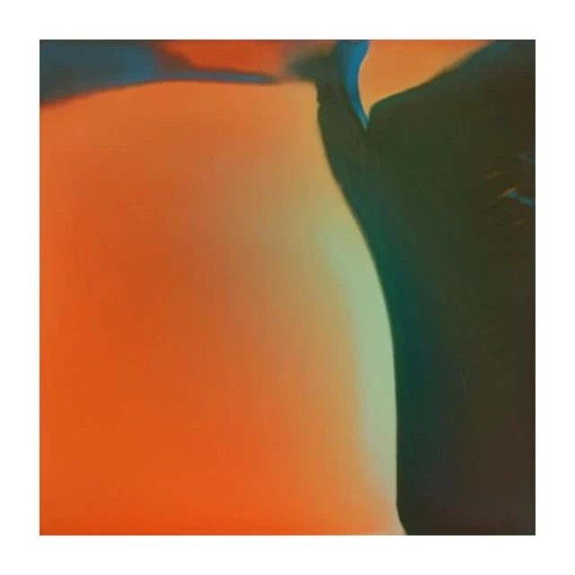 Abstract photo featuring a blend of orange, teal, and dark blue creating a soft, diffused gradient with blurred edges and gentle color transitions.