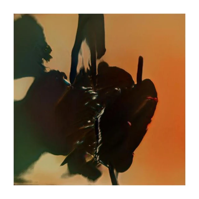 Abstract view of a dark, glossy substance on a stem against a gradient orange background, creating a unique and textured composition.