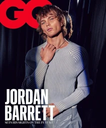 Model Jordan Barrett wearing a light blue ribbed sweater with a chain necklace in a portrait photographed by Steven Chee.