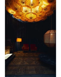 Interior room with an overhead canopy of illuminated yellow parasols and two red armchairs by Paul Barbera