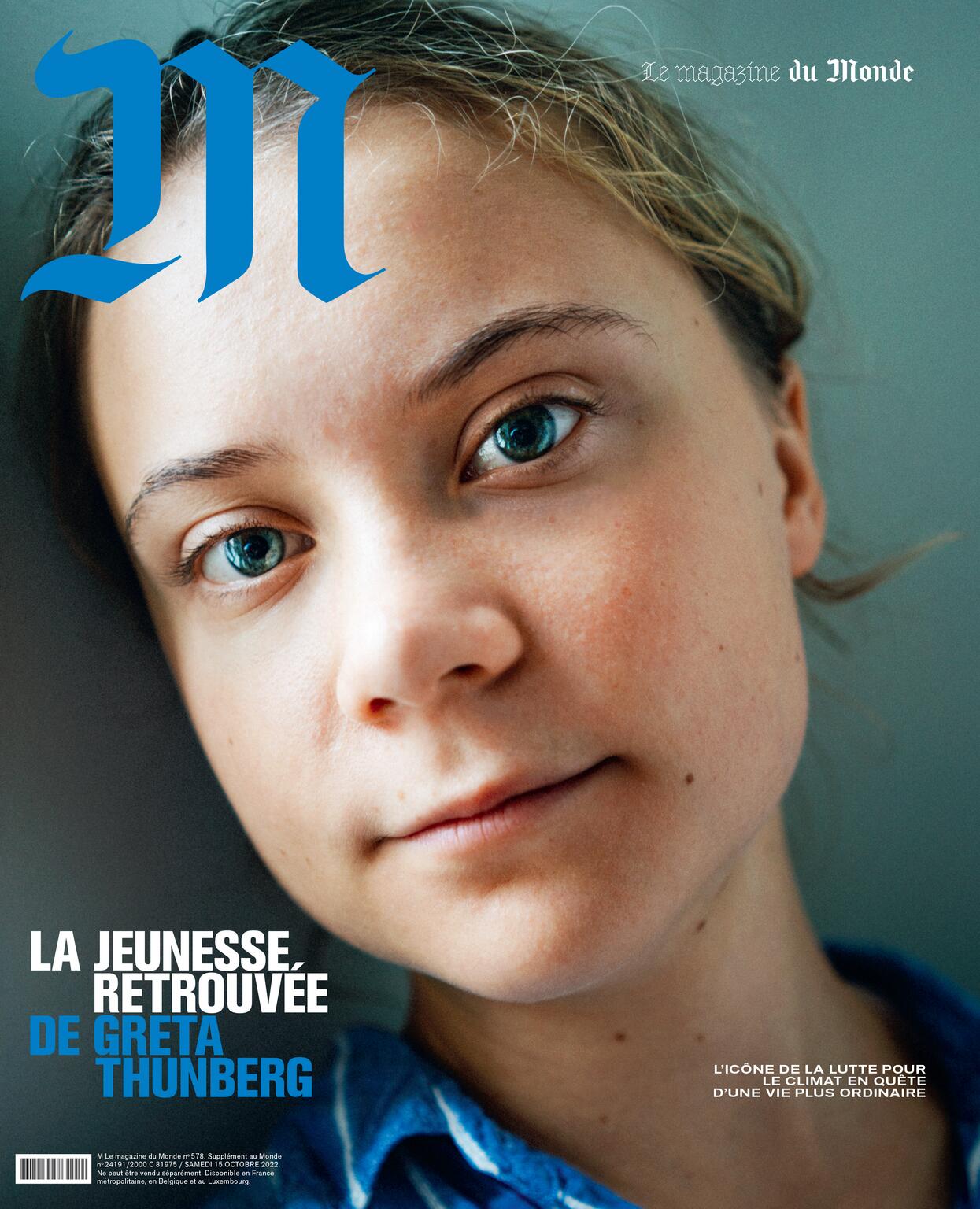 Close-up magazine cover featuring Greta Thunberg with blue eyes and a blue striped shirt against a muted blue background, in portrait orientation.