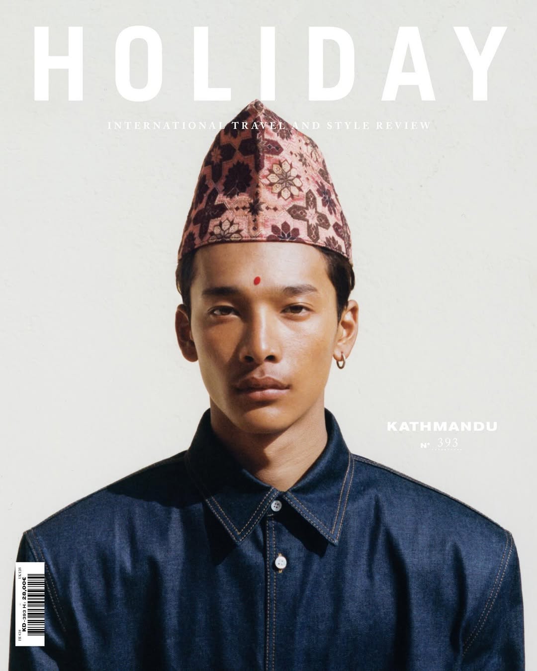 Magazine cover featuring a young adult male wearing a floral patterned hat and dark blue denim jacket looking directly at the viewer.