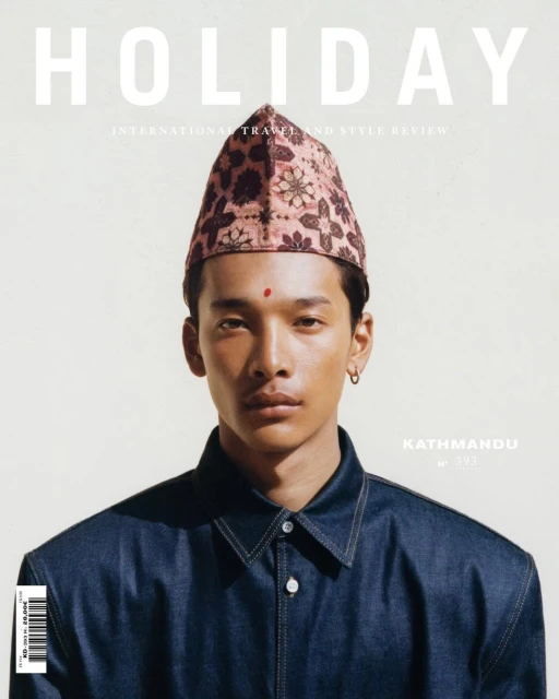 Magazine cover featuring a young adult male wearing a floral patterned hat and dark blue denim jacket looking directly at the viewer.
