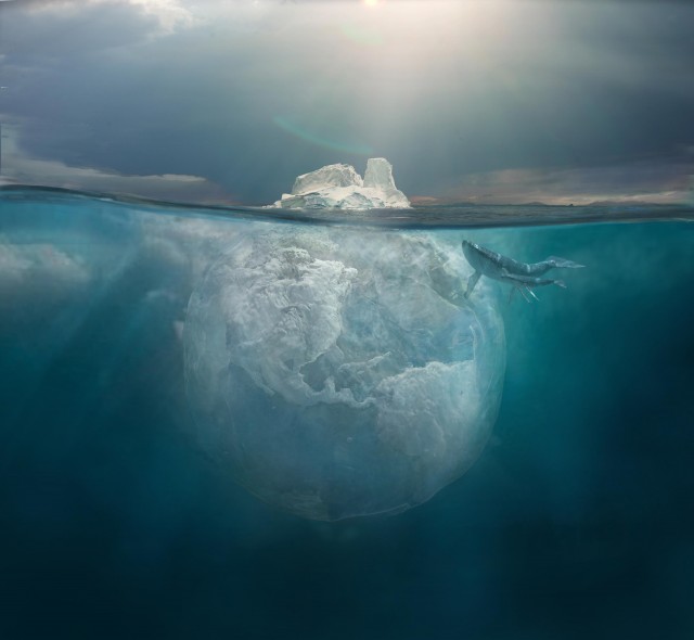 Ocean scene with a large, transparent plastic bag resembling an iceberg underwater, accompanied by two whales near the water surface.