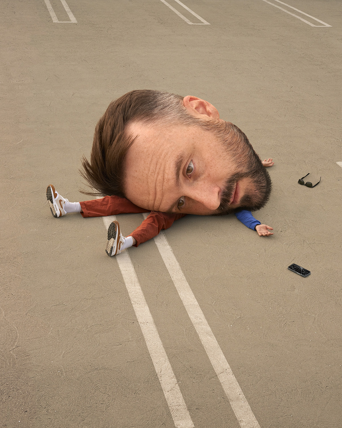 Surreal digital art of adult man with giant head laying on cracked asphalt parking lot, wearing casual clothes with sunglasses, cell phone.