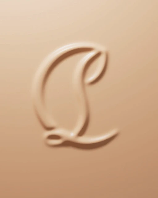 Close-up shot of beige makeup product with an embossed logo design. Cosmetic background with smooth and glossy texture.