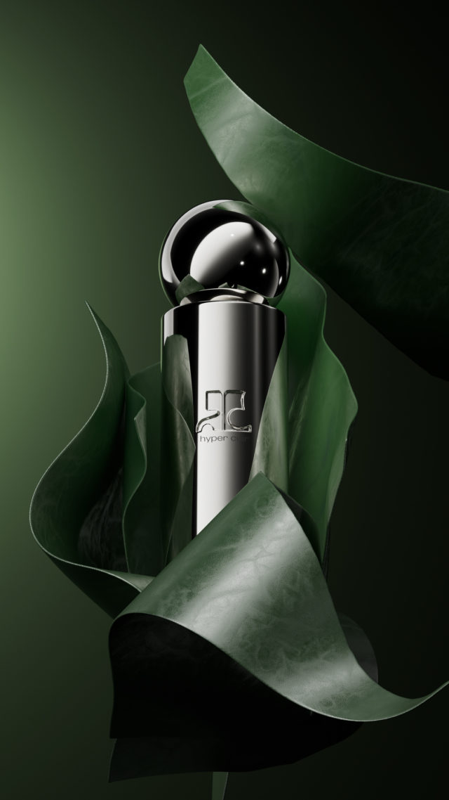 Elegant product shot: A silver perfume bottle with a spherical cap is nestled in layers of green leaves against a matching green backdrop.