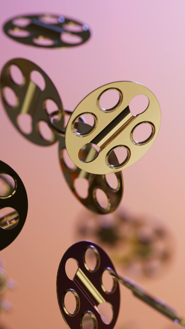 Abstract CGI art rendering of golden circular objects with linear slots floating on a gradient pink background with depth of field.