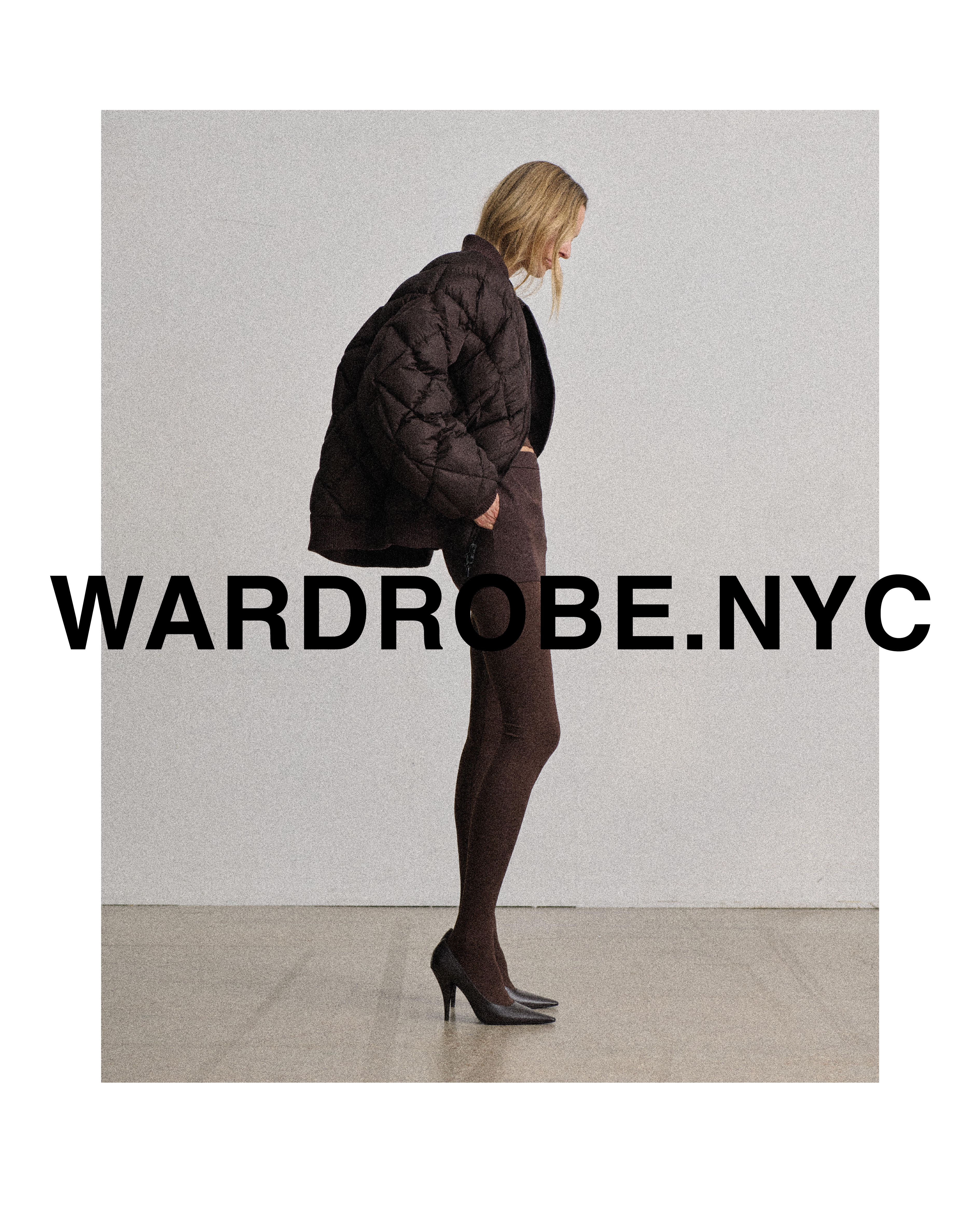 A woman poses in a studio wearing a brown quilted jacket, matching leggings, and heels. The image promotes wardrobe.nyc.