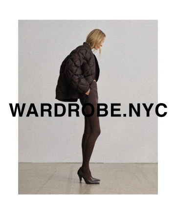 A woman poses in a studio wearing a brown quilted jacket, matching leggings, and heels. The image promotes wardrobe.nyc.