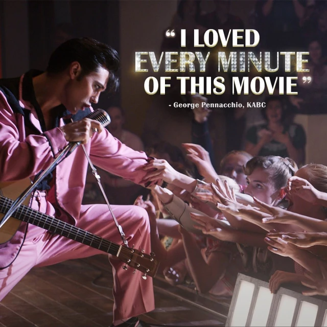Singer in pink suit performs with guitar before a crowd. Quote overlay reads, 'I LOVED EVERY MINUTE OF THIS MOVIE - George Pennacchio, KABC.'