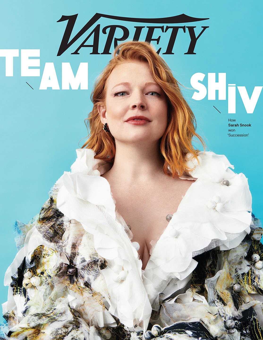 Variety magazine cover featuring a portrait of Sarah Snook with red hair, wearing a white and floral ruffled jacket, set against a light blue background.