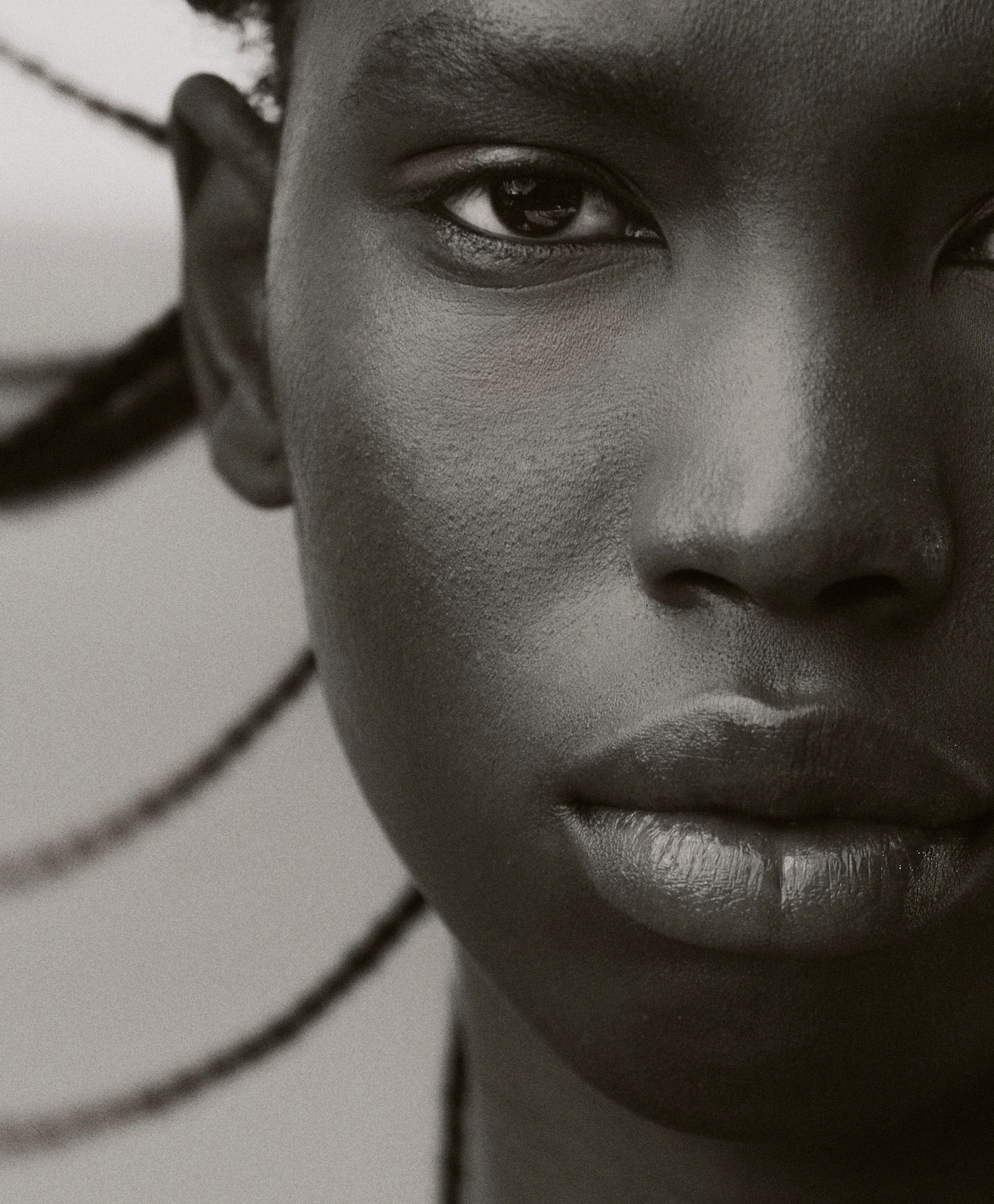 Extreme close-up portrait of a Black woman with braided hair styled by Max Serrano in Sydney
