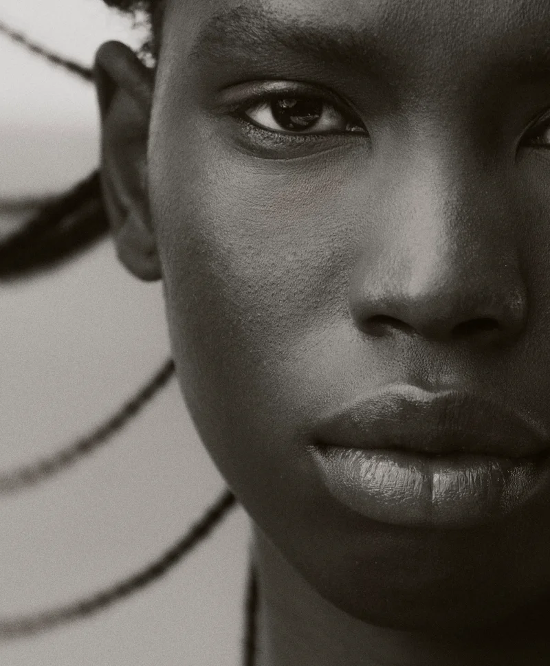 Extreme close-up portrait of a Black woman with braided hair styled by Max Serrano in Sydney