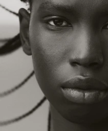 Extreme close-up portrait of a Black woman with braided hair styled by Max Serrano in Sydney