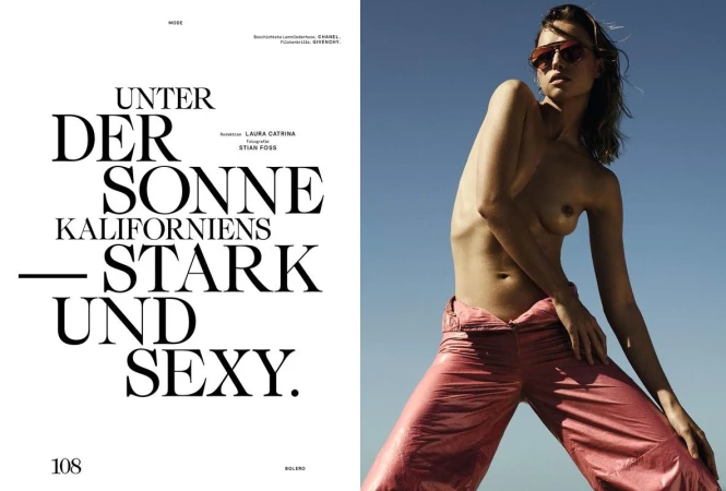 Model wearing pink metallic trousers and tinted sunglasses posing outdoors against a clear blue sky