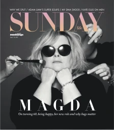 Monochrome magazine cover featuring a woman wearing dark sunglasses with multiple hands adjusting her hair and makeup.