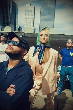 Group of four people on a rooftop wearing sunglasses and casual clothing against a city skyline background.