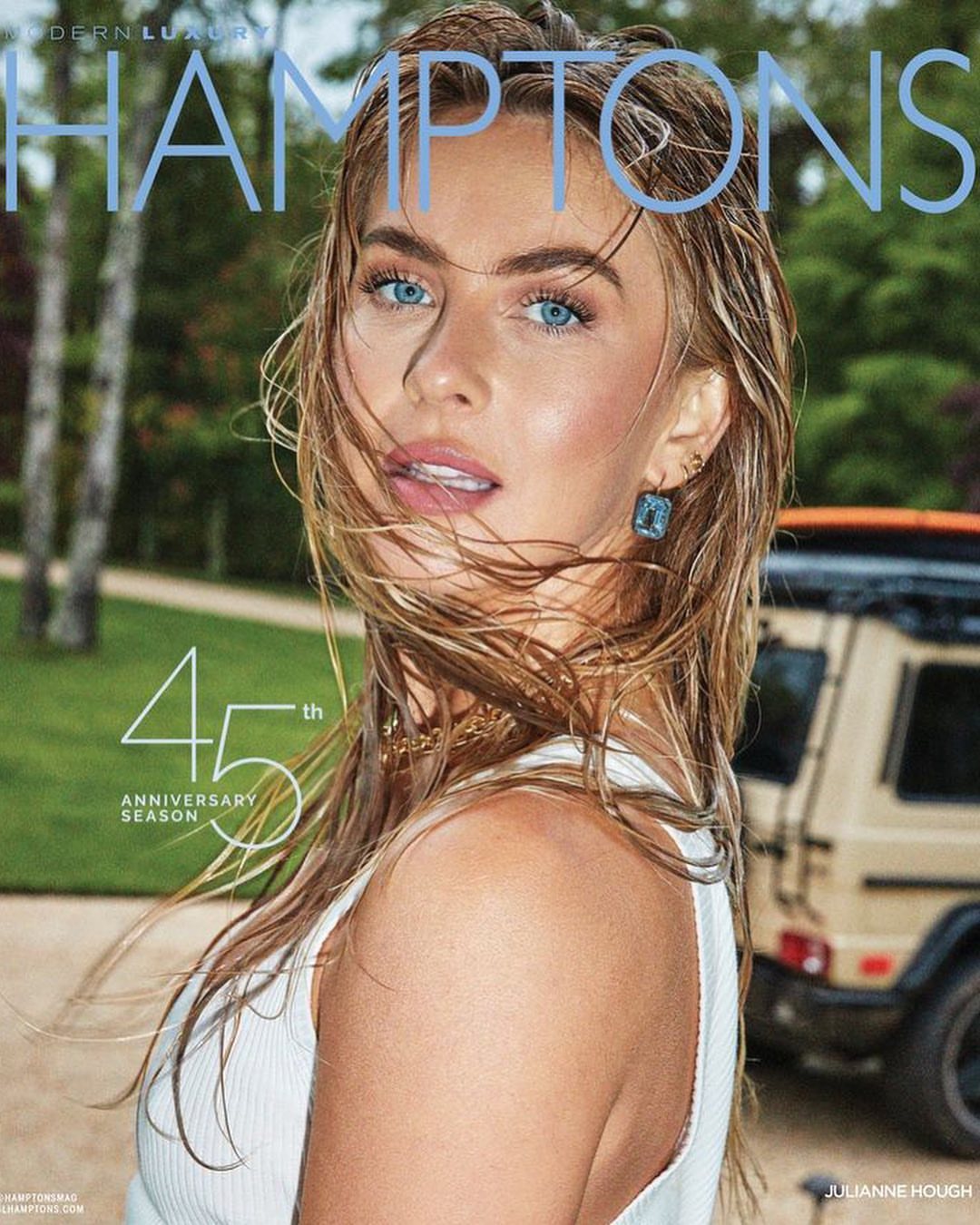 Portrait of Julianne Hough with wet hair and blue eyes wearing a white top with a light-colored vehicle in the background