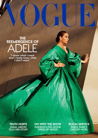 Vogue magazine cover featuring Adele wearing a green gown, side view, against a neutral backdrop with magazine text and branding.