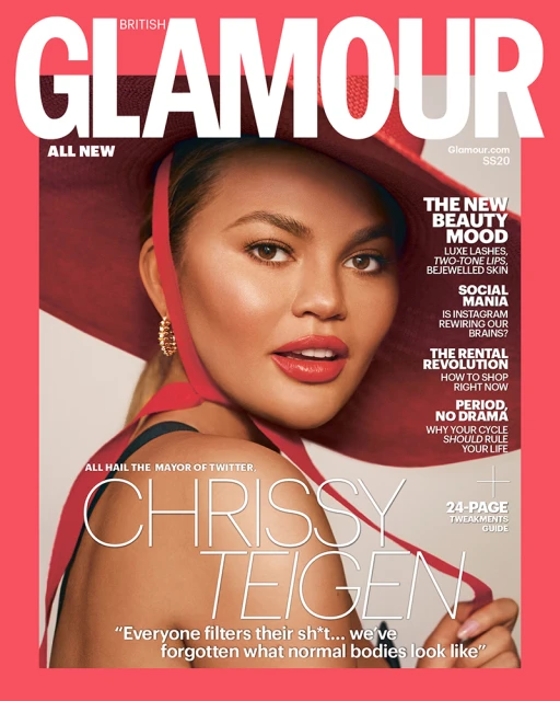 Chrissy Teigen on a British Glamour cover, wearing a red hat and lipstick, with the magazine's text headlines, a bright coral-pink background.