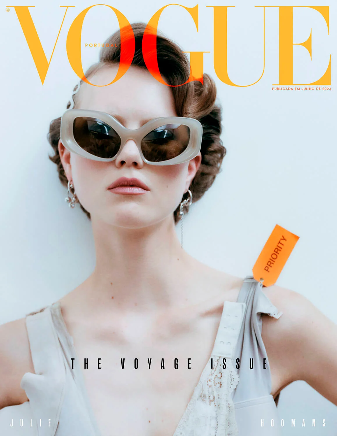 Vogue Portugal magazine cover featuring a fair-skinned woman with an updo wearing oversized sunglasses and a light-colored outfit.