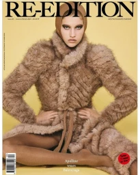 Model wearing a textured brown faux fur coat and matching cap against a solid yellow backdrop